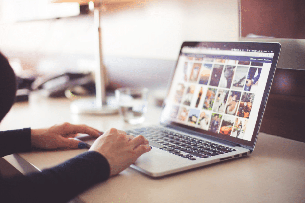 a lady looking at pictures on a computer