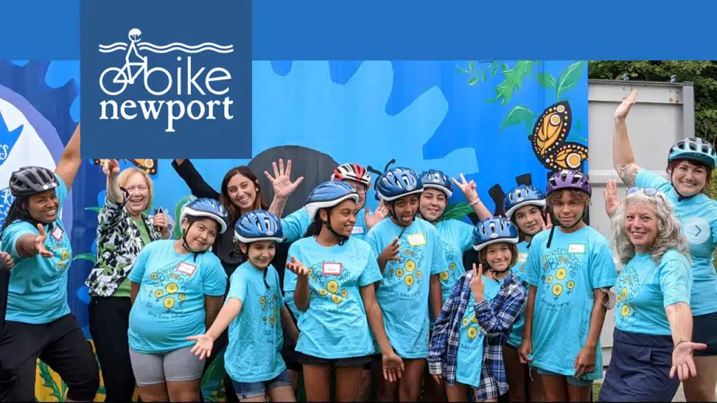 A group of kids wearing bicycle helmets