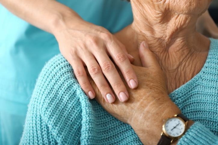 a nurse holding a woman's hand