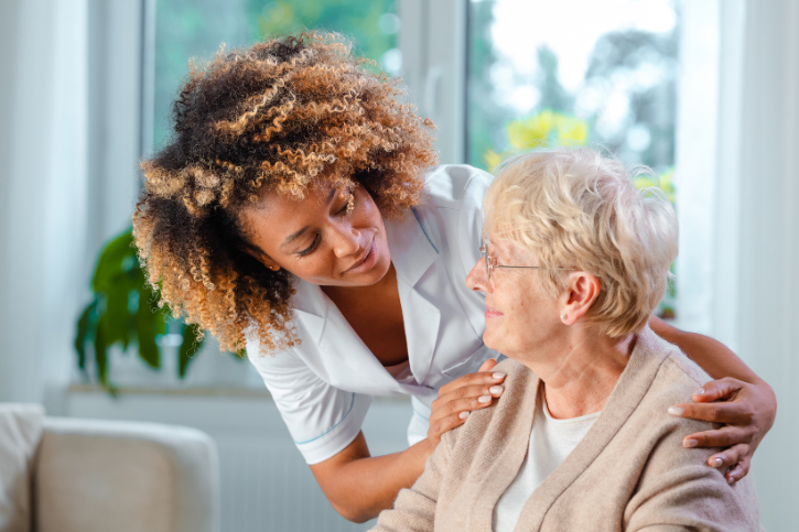 nursing home staff talking to an elderly woman