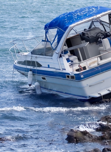 a boat capsized on rocks