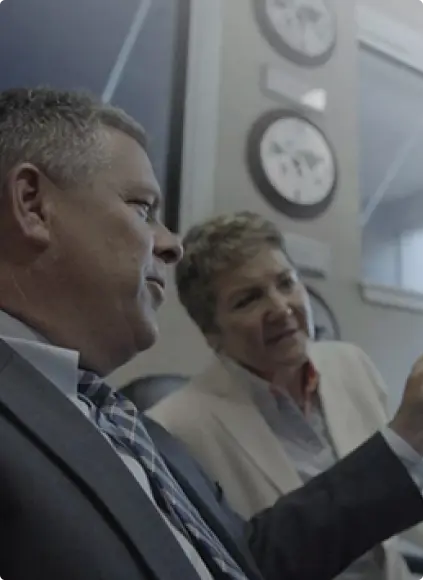 a man and a woman looking at a document