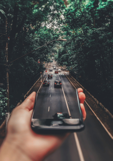 a hand leading to a road