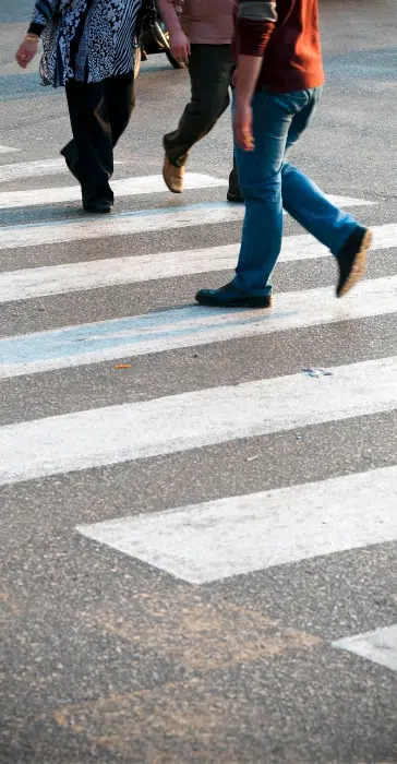 a group of people using a crosswalk in rhode island