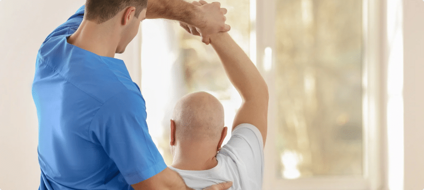 a doctor helping a person in physical therapy