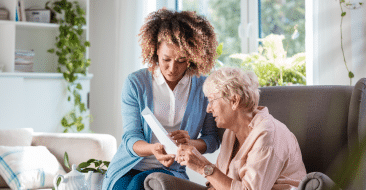 a woman talking to an elderly woman