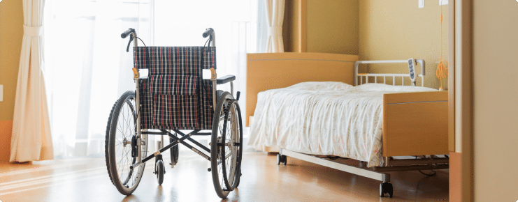 a wheelchair and bed in a hospital room