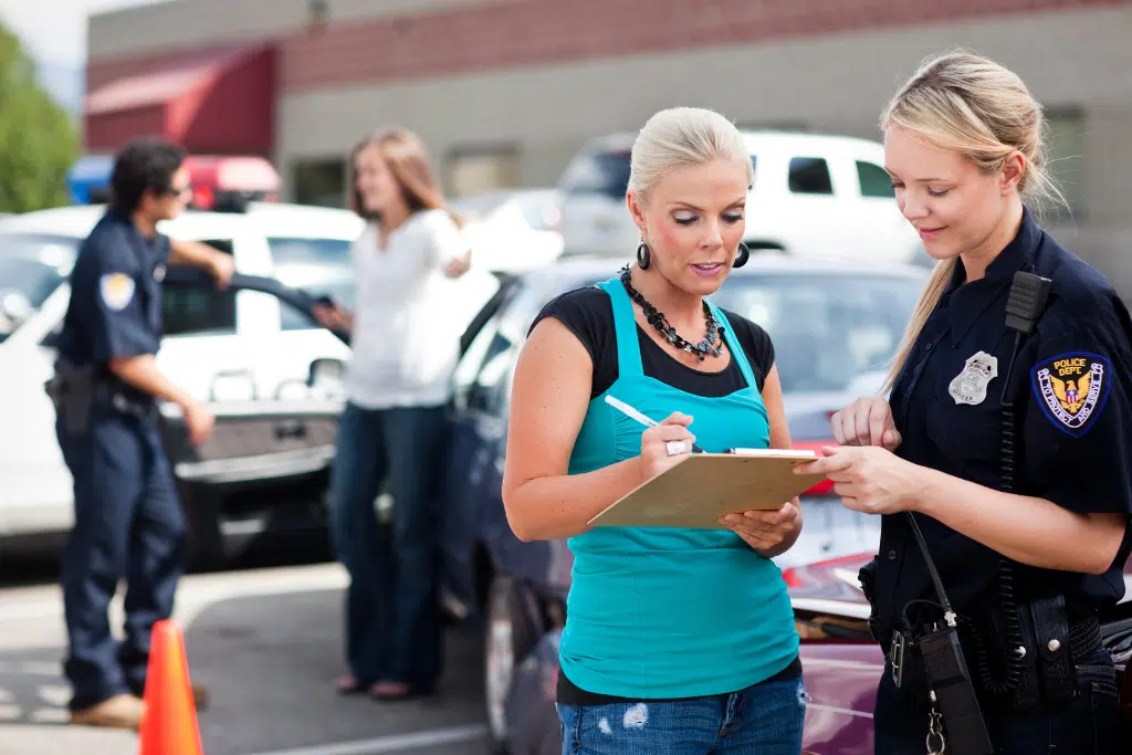 a woman talking to a police officer