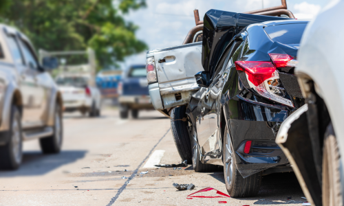 A car crash scene with a damaged vehicle