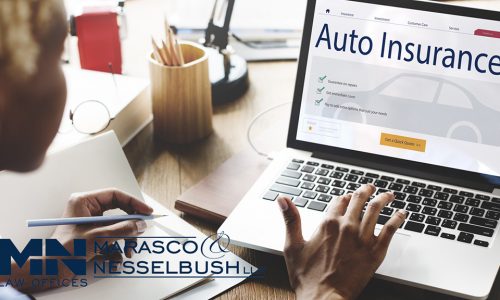 a person using a laptop to browse auto insurance information