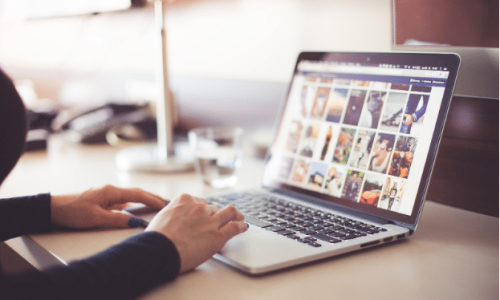 a lady looking at pictures on a computer