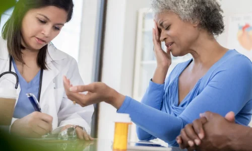 a-woman-and-her-husband-talking-to-a-doctor