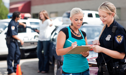 a woman talking to a police officer