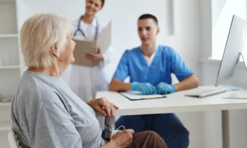 A woman having a conversation with doctors in a medical setting.