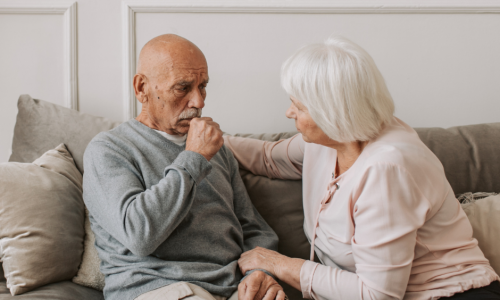 an elderly man coughing