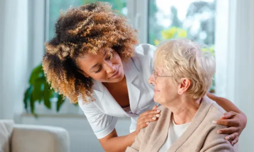 Nursing home staff interacting with an elderly woman.